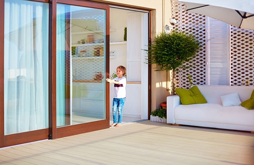Image of Boy Opening and Closing Sliding Glass Door